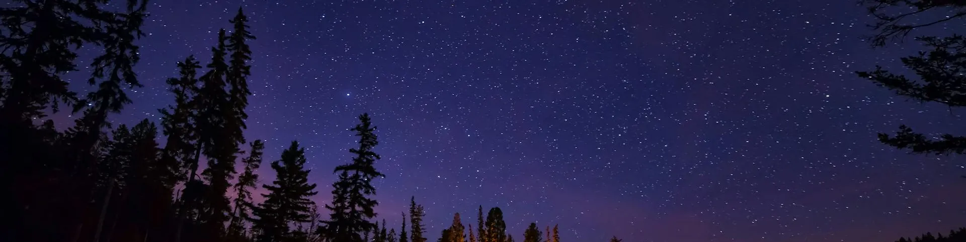 Peaceful starry night sky over a calm lake